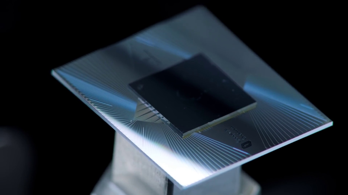Google's Sycamore superconducting quantum processor: a silvery chip with control wires radiating toward a dark central square of qubits